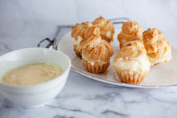 Vanilla Soes Cakes (Sus Vla), served in white plate, copy space. Close-up and selective focus image.