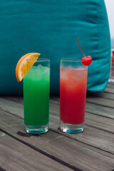 Summer Cocktails drinks. Classic alcoholic long drink mocktail versions, various beverages, lemonades with berries, lime, orange. Shoot around Pool