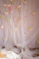Beige tulle background with flower buds.