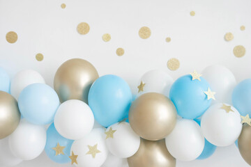 Garland of white, blue and gold balloons. Decor for baby shower.