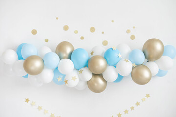 Garland of white, blue and gold balloons. Decor for baby shower.