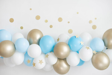 Garland of white, blue and gold balloons. Decor for baby shower.
