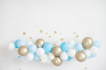 Garland of white, blue and gold balloons. Decor for baby shower.