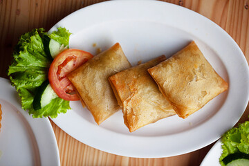 Martabak telur mini, Indonesian street food. fried wrap filled with eggs,minced meat, and vegetables.