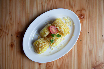 Singkong goreng or Cassava Fries is traditional culinary from Indonesia. Flat lay with wooden background