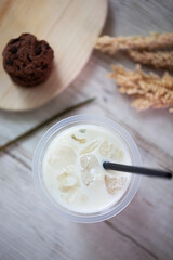 Flat lay Vanilla Milk shake in plastic glass on a white background. vanilla milkshake in takeaway cup