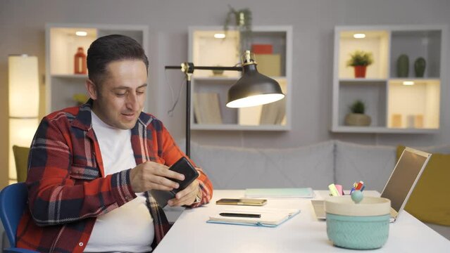 Man saving money in piggy bank.
