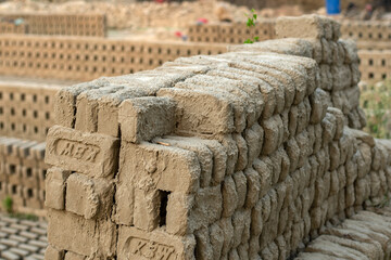 5th June, 2023, Burul, West Bengal, India: Blocks of hand made traditional bricks stack under the...