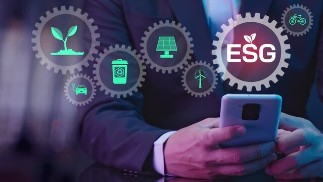 Businessman using smartphone with ESG icon and virtual of gear. Net zero greenhouse gas emissions target. Climate neutral long term strategy. Ecological, renewable energy and save environment concept.