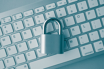 Flat lay padlock on computer keyboard background in monochrome tone. Encryption username password in online internet website, cyber security, privacy data information protection, firewall concept.