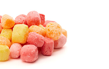 Freeze Dried Rainbow Flavored and Pastel Colored Chewy Candy Squares on a White Background