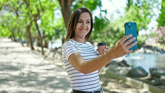 Middle eastern woman smiling confident making selfie with the phone at park