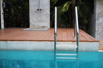 The swimming pool and the stairs leading to the swimming pool are made of stainless steel.