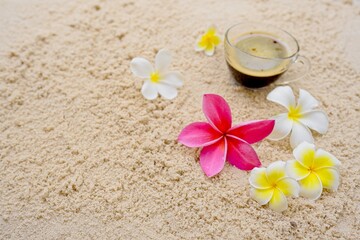 Fototapeta na wymiar frangipani flowers on sand