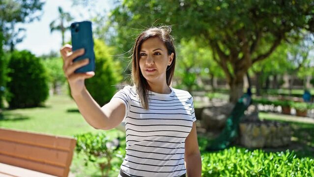 Middle eastern woman smiling confident making selfie with the phone at park