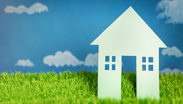 House on green field with blue sky with copy space for home loan real estate concept photo