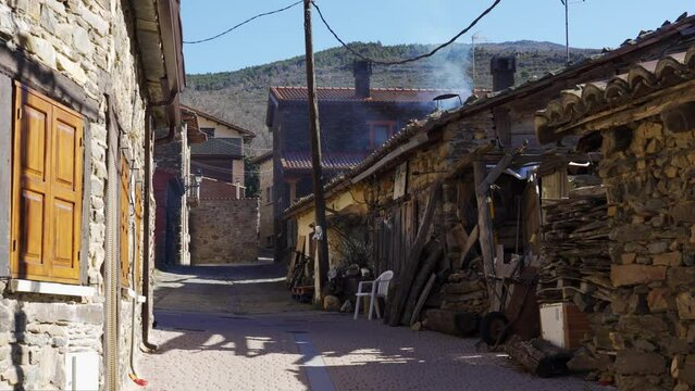 Picturesque alley formed by stone houses in the mountain of the Sierra de Madrid, Puebla de la Sierra