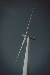 An image looking up a windmill or wind turbine.