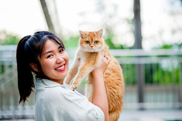 Woman holding cat playing at home with love for cats The smile glints in his bond with his fluffy...