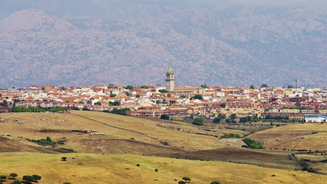 View of the city of Colmenar Viejo next to the mountains of Guadarrama Park in Madrid.