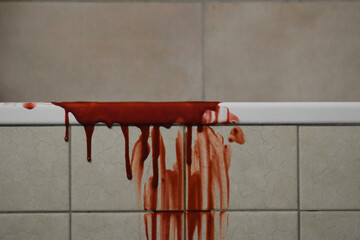 A horror concept of a blood-soaked bathtub side.