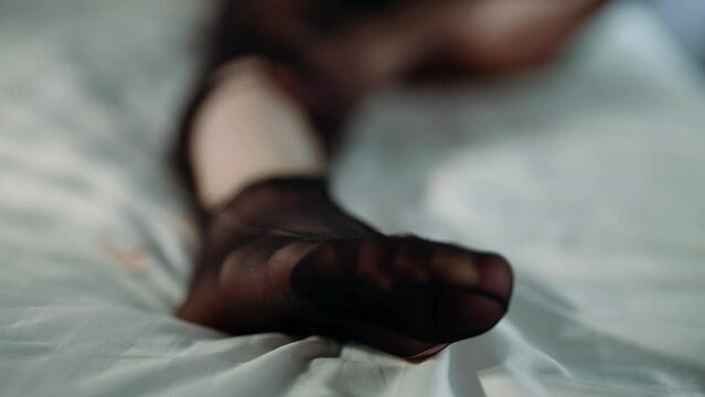 Close-up of a woman foot in torn nylon tights
