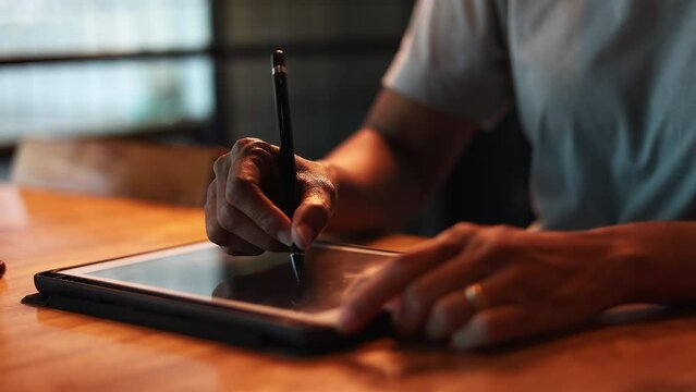Woman Drawing On Digital Tablet is stoke footage for market films and cinematic in commercial scene.