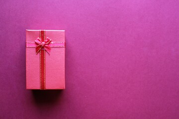Valentine present. Red gift box and ribbon for romantic couple.