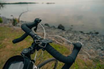 The handlebar of a sports bike with the closeup of brake handles and the shifter.