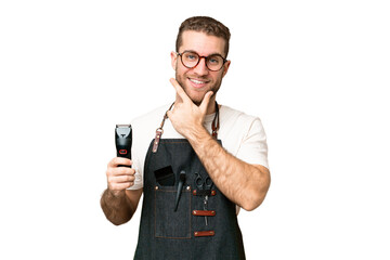 Barber man in an apron over isolated chroma key background happy and smiling
