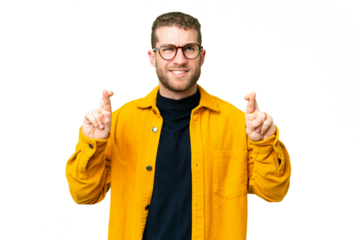 Young handsome blonde man over isolated chroma key background with fingers crossing and wishing the best