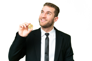 Young business blonde man holding a Bitcoin over isolated chroma key background thinking an idea while looking up