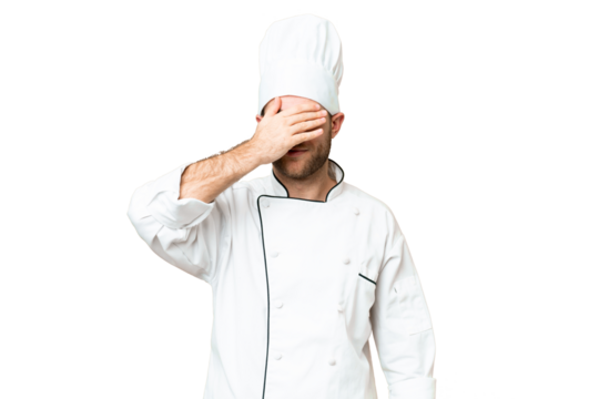Young blonde man Chef over isolated chroma key background covering eyes by hands. Do not want to see something