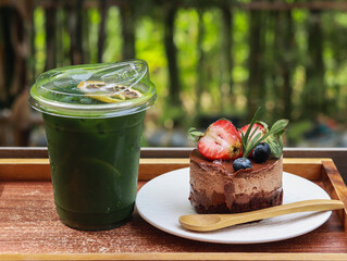 chocolate cake decorated with strawberries and persimmons white glass plate