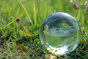 Nature photography of crystal ball with solar system in it, space, future environment and ESG concept