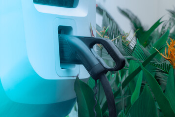 Power supply of EV charging station with electric vehicle charging cable and port at an electric...