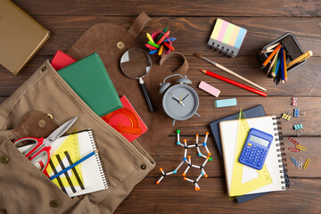 Back to school - books and school backpack on the desk in the auditorium, Education concept.