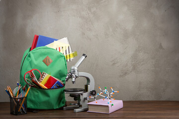 Back to school - books and school backpack on the desk in the auditorium, Education concept.