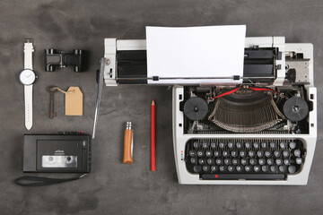 Fototapeta na wymiar vintage typewriter and tape recorder on the table with blank paper on the desk - concept for writing, journalism, blogging