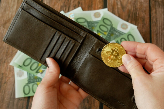 Bitcoin new virtual money in wallet and euro banknotes. Exchange bitcoin for a euro cash. Concept. Closeup