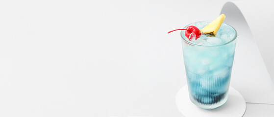 Glass of Blue Lagoon cocktail on light background with space for text - obrazy, fototapety, plakaty