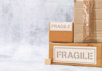 High angle shot of fragile boxes along with wooden cube placed on marble surface.