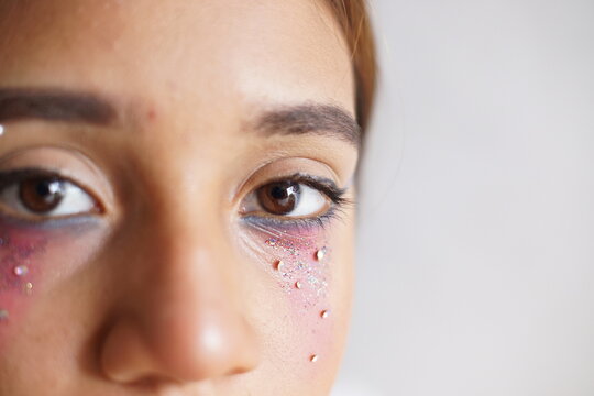 Teenage latin hispanic girl putting on makeup
