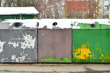 View of garbage containers in city on winter day