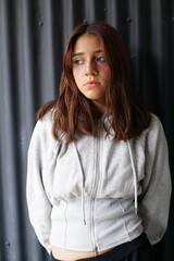 Portrait of a teenage latin hispanic girl with black metal background