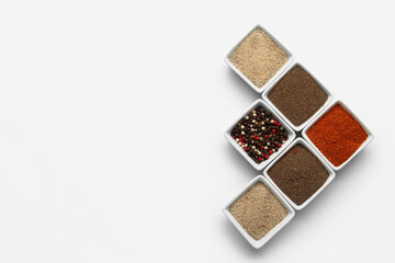 Composition with bowls of fresh aromatic spices on light background