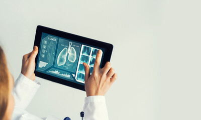 Close of female doctor hands working with tablet pc computer - 614085980
