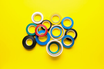 Adhesive tape rolls on yellow background