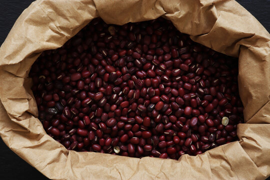 Photograph of adzuki beans in a brown paper bag