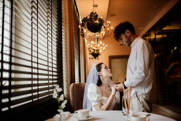 loving couple of newlyweds bride and groom in a restaurant